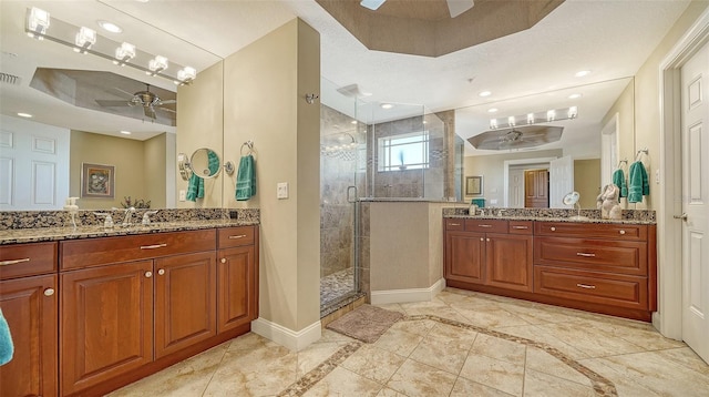 505 S Orange Ave Unit 501, Sarasota, FL 34236 - full bath with ceiling fan, a shower stall, baseboards, two vanities, and inlaid floor details