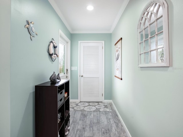 doorway with hardwood / wood-style flooring and crown molding