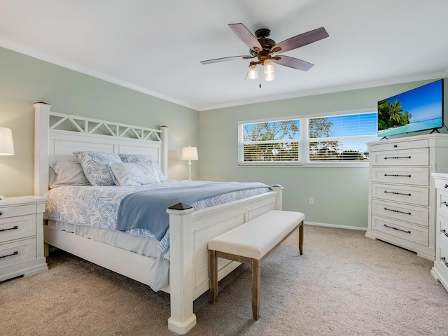 bedroom featuring baseboards, ornamental molding, a ceiling fan, and light colored carpet