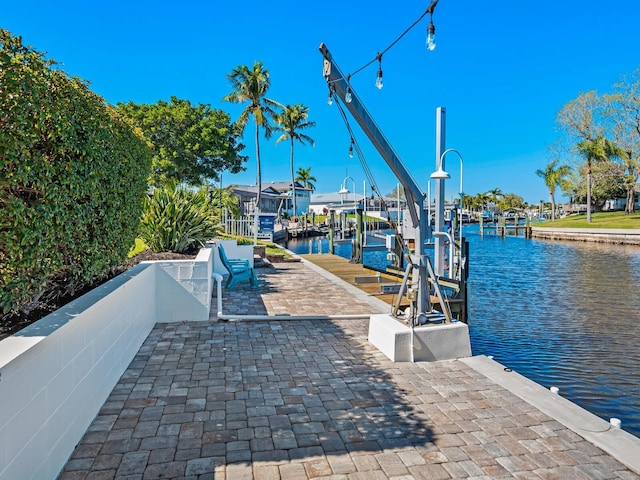 dock area with a water view and boat lift