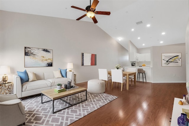 living room with ceiling fan, dark hardwood / wood-style floors, and high vaulted ceiling