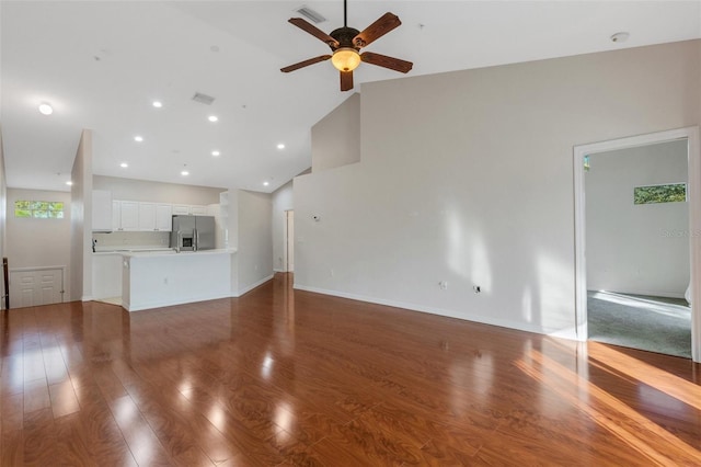 unfurnished living room featuring high vaulted ceiling, hardwood / wood-style floors, and ceiling fan