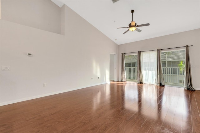 empty room featuring wood-type flooring, high vaulted ceiling, and ceiling fan