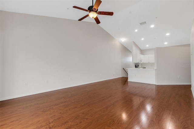 unfurnished living room with dark wood-type flooring, ceiling fan, and high vaulted ceiling