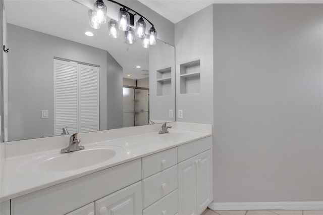 bathroom with vanity and a shower with door