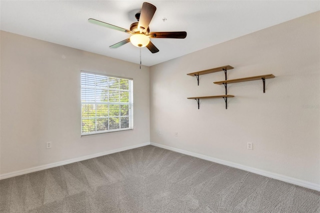 carpeted empty room featuring ceiling fan