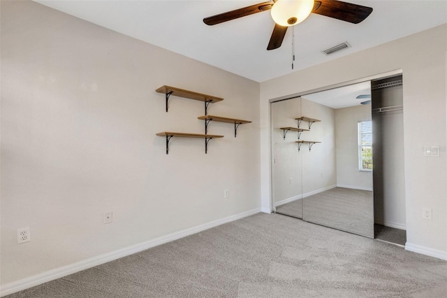 unfurnished bedroom featuring carpet floors, a closet, and ceiling fan