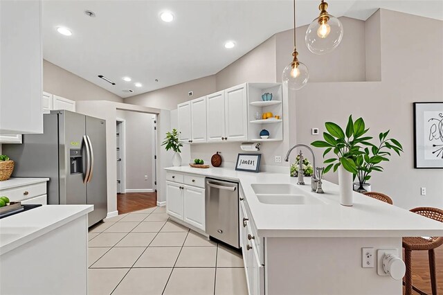6706 Fairway Gardens Dr Unit 6706, Bradenton, FL 34203 - kitchen featuring stainless steel appliances, a breakfast bar area, light countertops, white cabinets, and decorative light fixtures