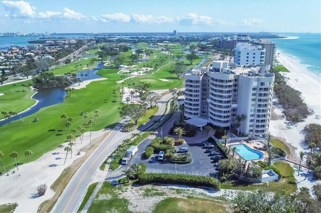 drone / aerial view featuring a beach view and a water view