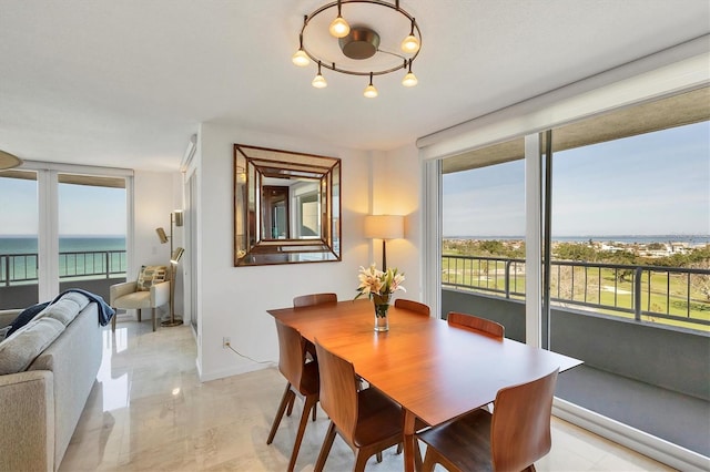 dining space with plenty of natural light and a water view