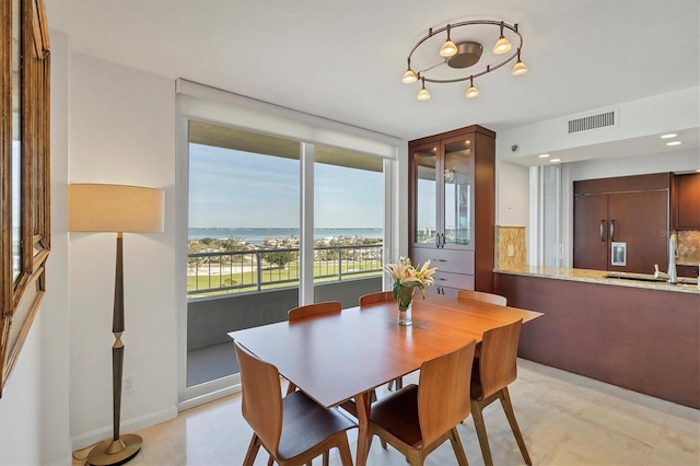 dining area with a water view and sink