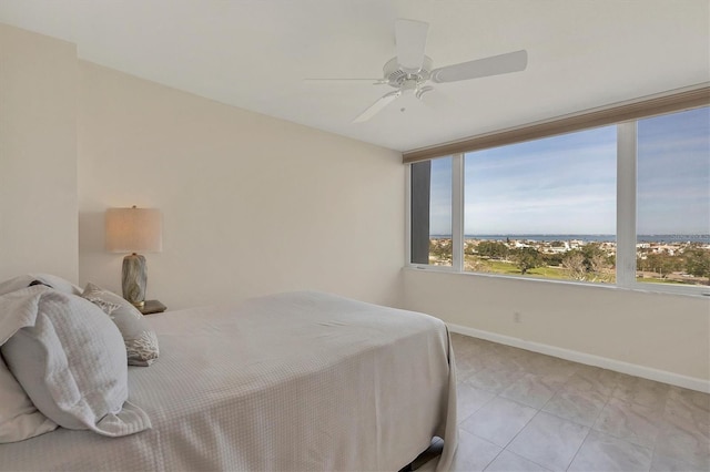 bedroom with light tile patterned floors and ceiling fan