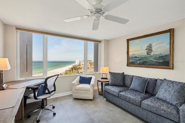 home office with a water view and ceiling fan