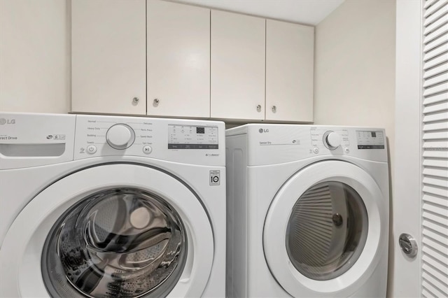 laundry room with cabinets and separate washer and dryer