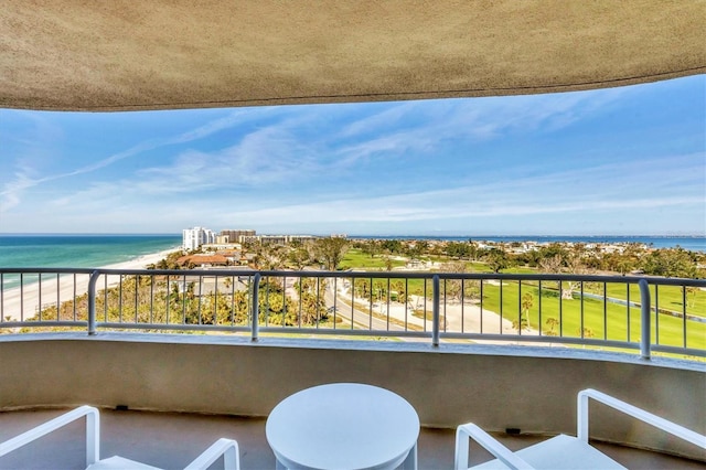 balcony featuring a beach view and a water view