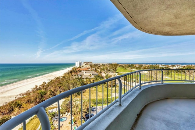 balcony featuring a beach view and a water view