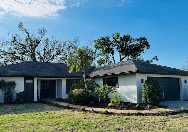 single story home with a garage and a front yard