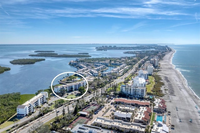 drone / aerial view featuring a water view and a beach view