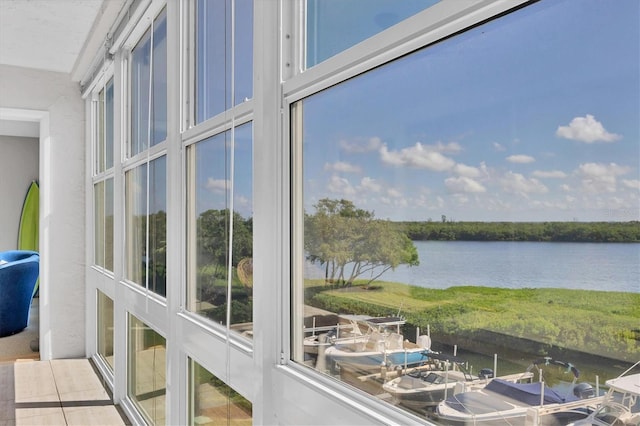 sunroom / solarium featuring a water view