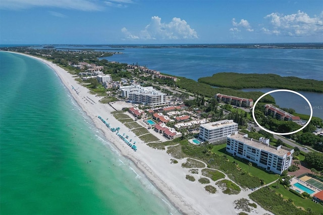 birds eye view of property with a water view and a view of the beach