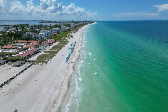 birds eye view of property featuring a water view and a beach view