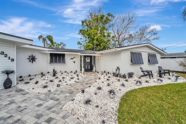 ranch-style home with a front lawn