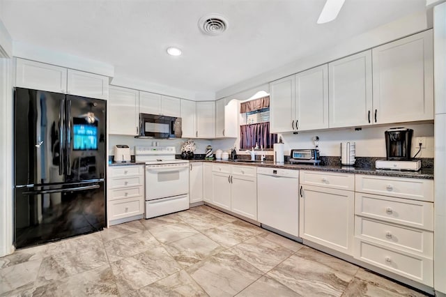 kitchen featuring white cabinetry, sink, black appliances, and dark stone countertops