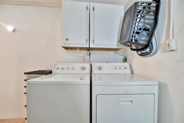 laundry area featuring cabinets and washing machine and clothes dryer