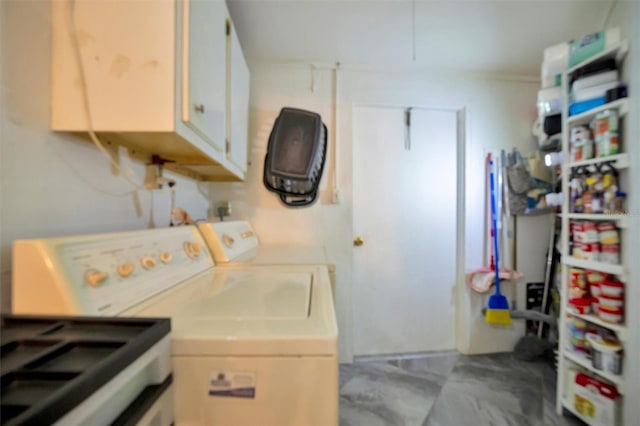 laundry room with cabinets and separate washer and dryer