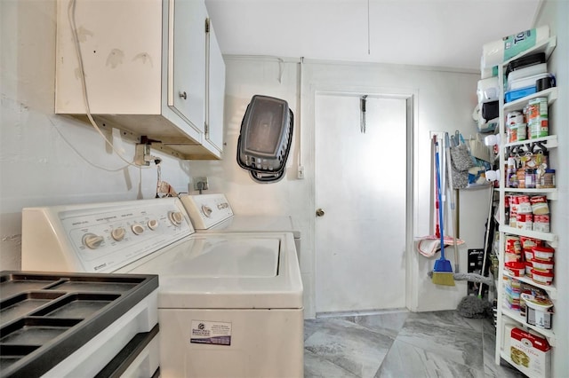 laundry room with cabinets, sink, and washing machine and clothes dryer