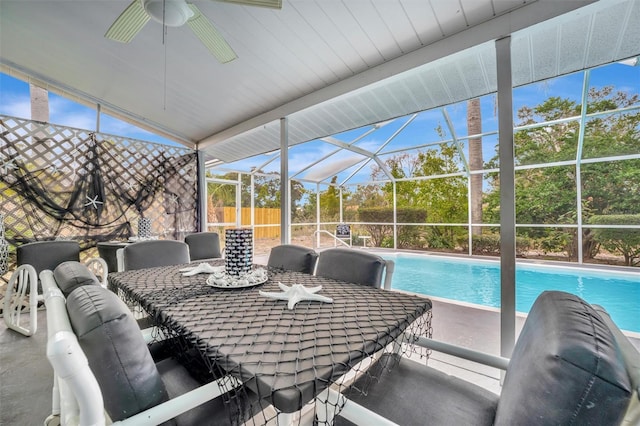 sunroom with ceiling fan and vaulted ceiling