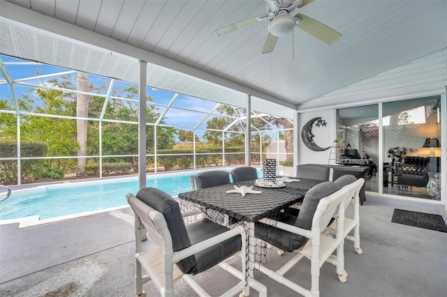 sunroom featuring ceiling fan, vaulted ceiling, and a wealth of natural light