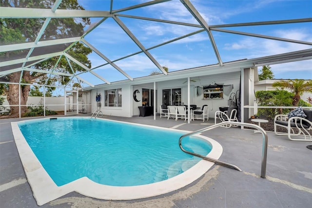 view of swimming pool with a lanai and a patio