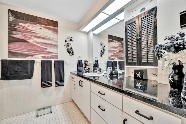 bathroom featuring tile walls, vanity, and tile patterned flooring