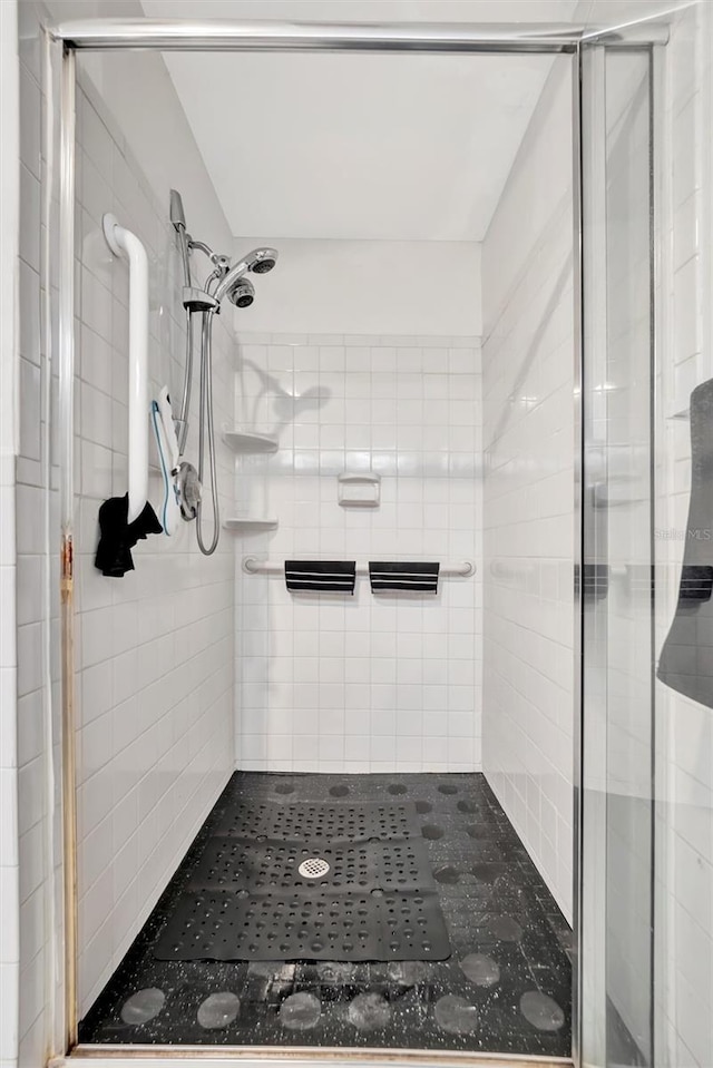 bathroom with a shower with door