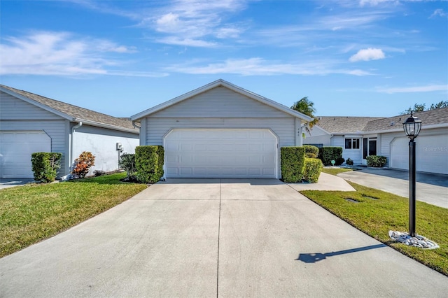 single story home with a garage and a front lawn