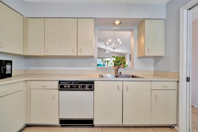 kitchen featuring light tile patterned flooring, sink, decorative light fixtures, white dishwasher, and cream cabinets