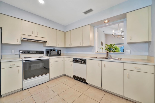 kitchen featuring cream cabinets, sink, light tile patterned floors, and white appliances