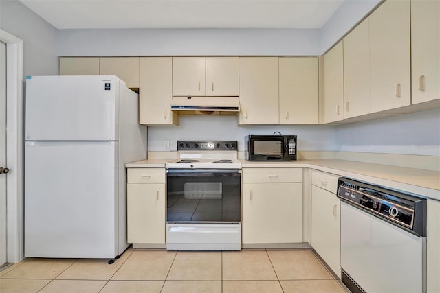 kitchen with white appliances, range hood, light tile patterned floors, and cream cabinetry