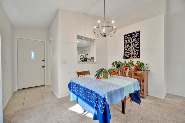 dining space featuring light colored carpet and a notable chandelier