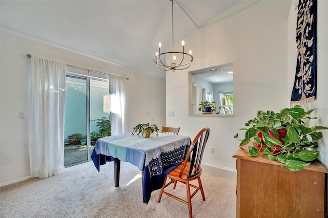 dining room featuring a chandelier and light carpet