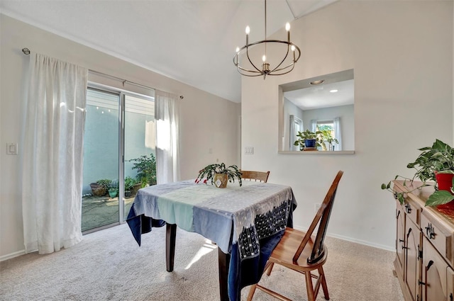 carpeted dining room featuring a notable chandelier