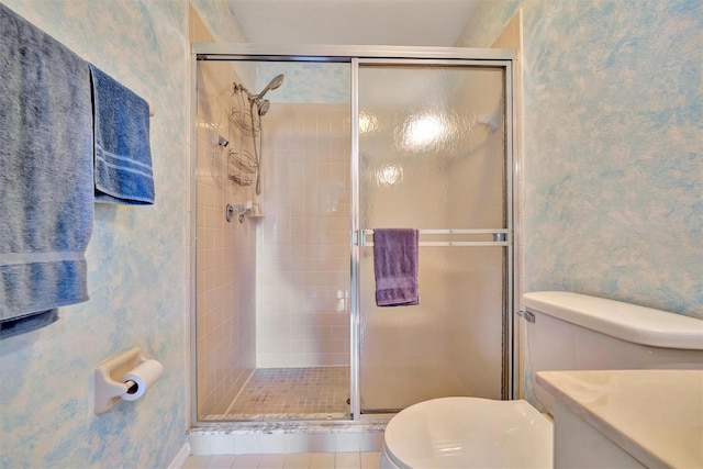 bathroom with vanity, tile patterned flooring, a shower with door, and toilet