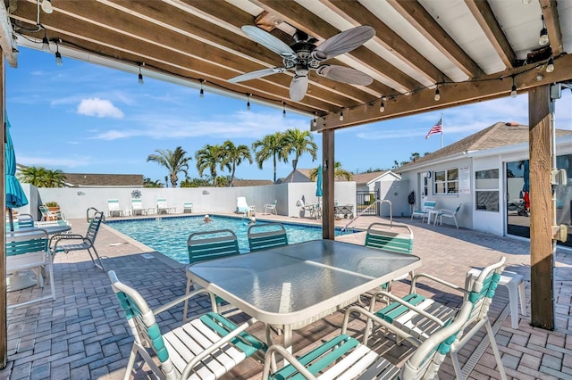 view of swimming pool with ceiling fan and a patio area