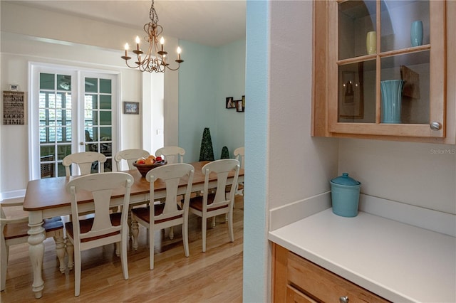 dining space with an inviting chandelier and light wood-type flooring