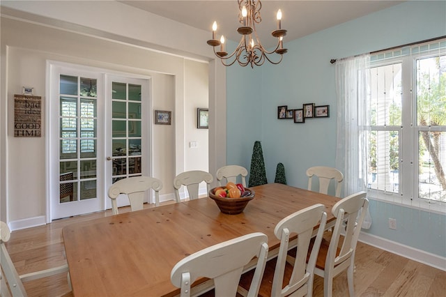 dining room with a chandelier and light wood-type flooring