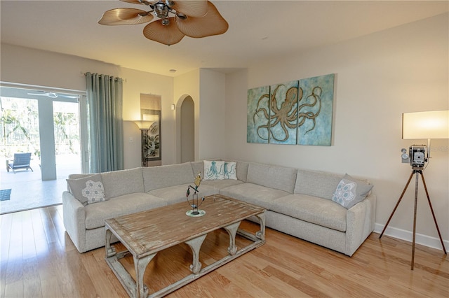 living room with hardwood / wood-style flooring and ceiling fan