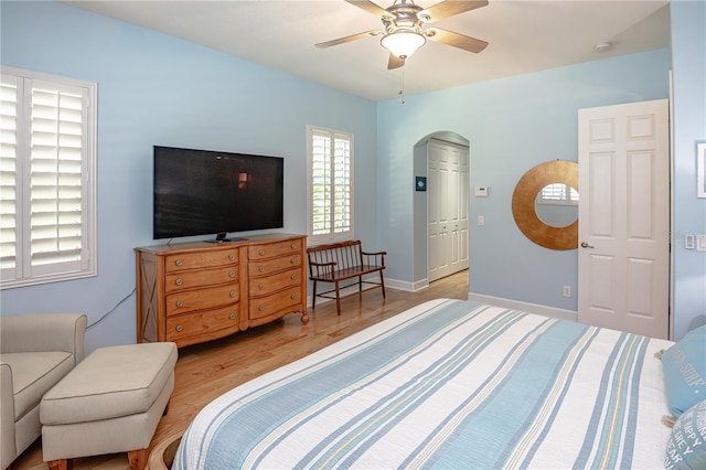 bedroom with light hardwood / wood-style flooring and ceiling fan