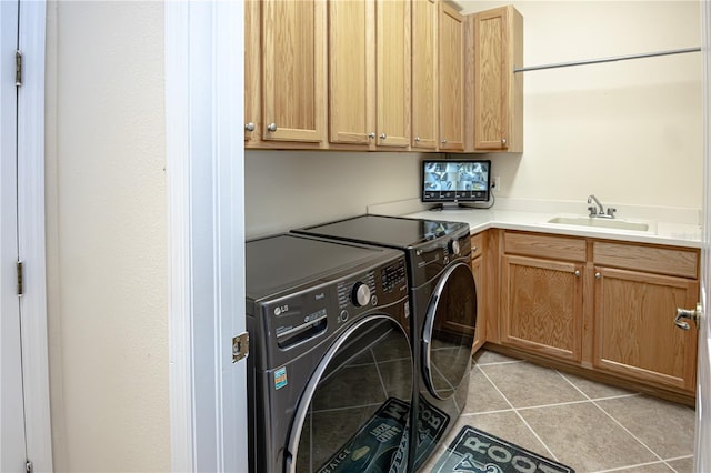 washroom with cabinets, light tile patterned flooring, sink, and independent washer and dryer