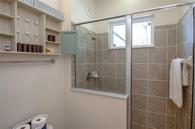 bathroom featuring tiled shower and toilet